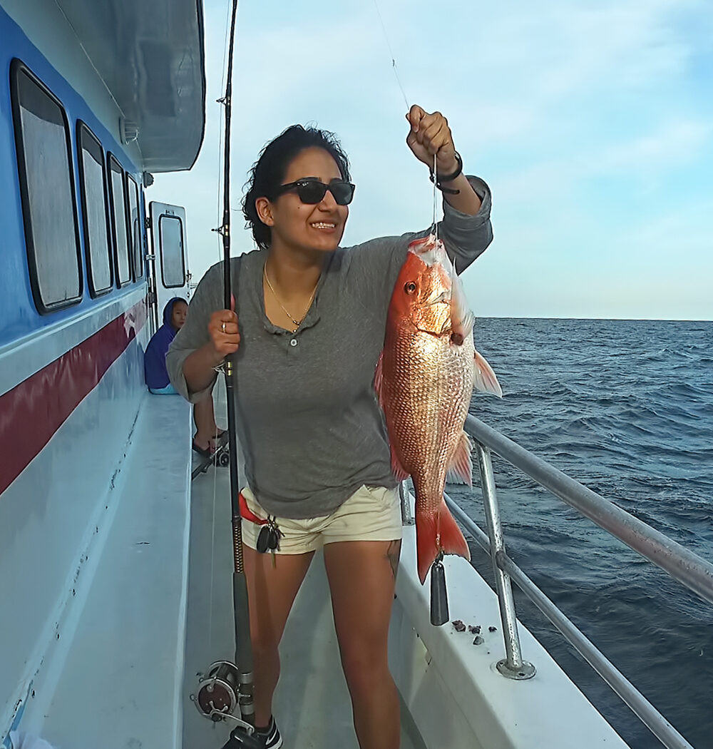 girl holding red snapper on destin fishing charter